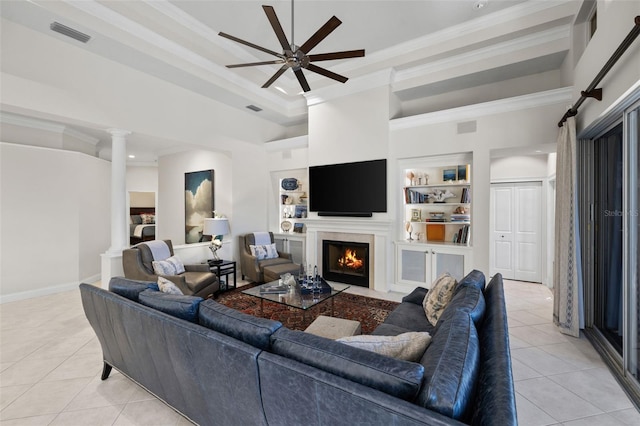 living room with ornate columns, light tile patterned floors, and crown molding