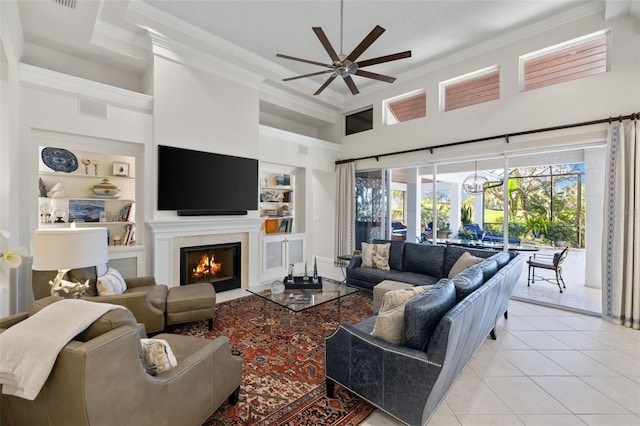 living room featuring light tile patterned floors, crown molding, a fireplace with flush hearth, and built in features