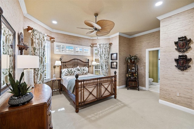 bedroom featuring carpet flooring, crown molding, baseboards, and ensuite bathroom