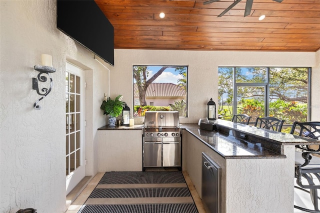 view of patio featuring a grill, an outdoor kitchen, and outdoor wet bar