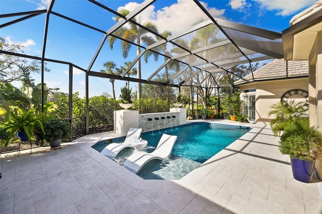 outdoor pool featuring a patio and glass enclosure