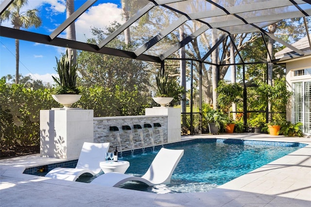 outdoor pool with glass enclosure and a patio area