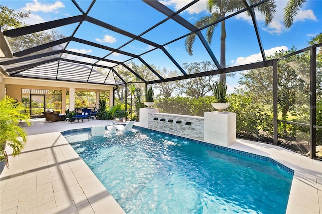 view of pool with a lanai and a patio area