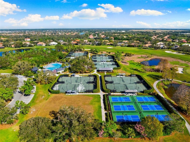 birds eye view of property featuring golf course view and a water view