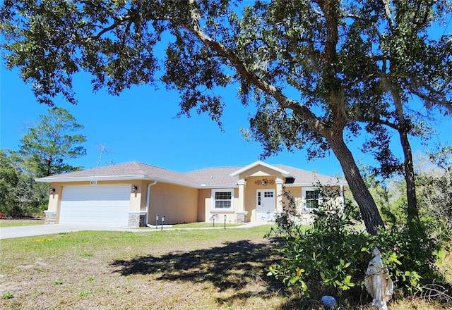 single story home with stucco siding, driveway, stone siding, a front yard, and an attached garage