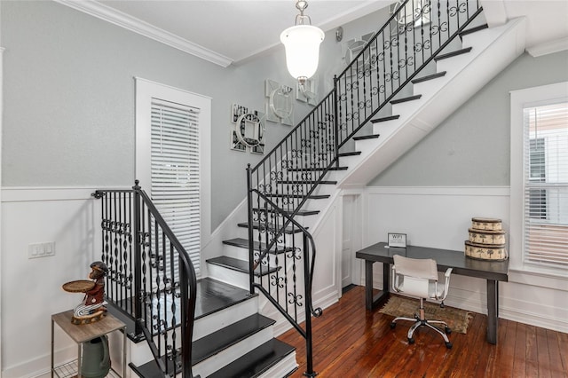 staircase with ornamental molding, baseboards, and hardwood / wood-style flooring