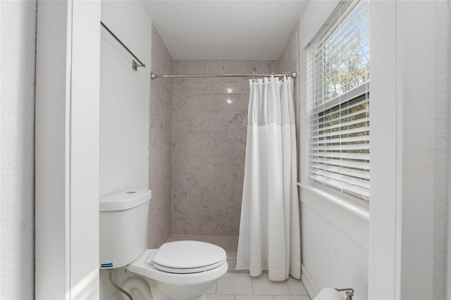 bathroom with toilet, tile patterned floors, and a shower with shower curtain