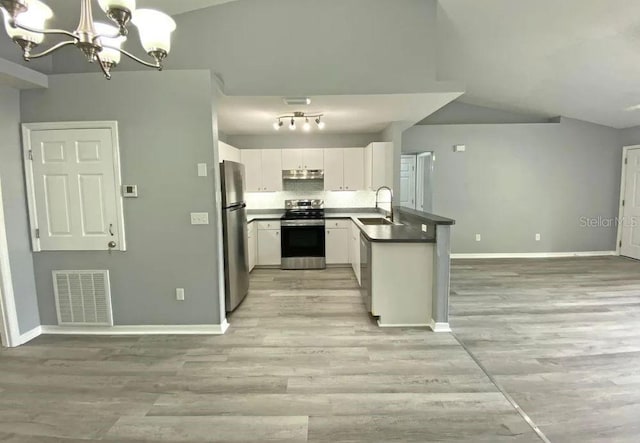 kitchen featuring visible vents, appliances with stainless steel finishes, an inviting chandelier, white cabinetry, and a sink