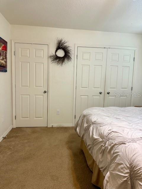 carpeted bedroom with baseboards