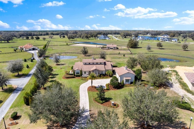 birds eye view of property with a water view and a rural view