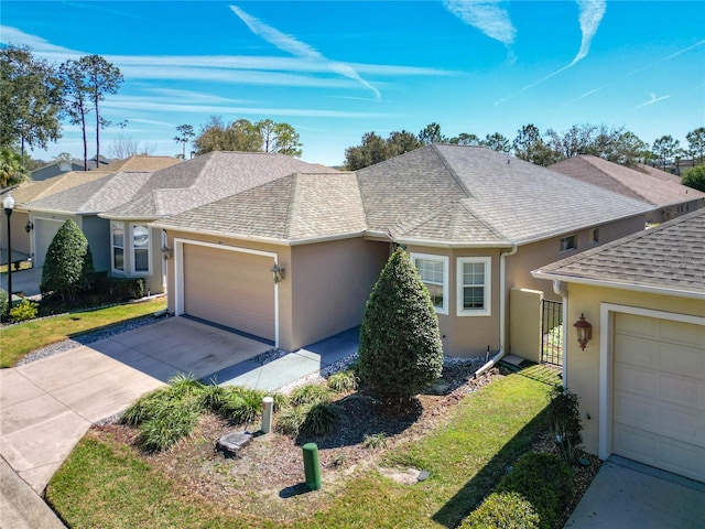 ranch-style home with a garage, driveway, roof with shingles, a front lawn, and stucco siding