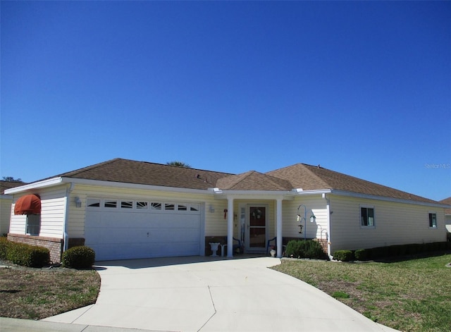 ranch-style house with an attached garage, driveway, and brick siding