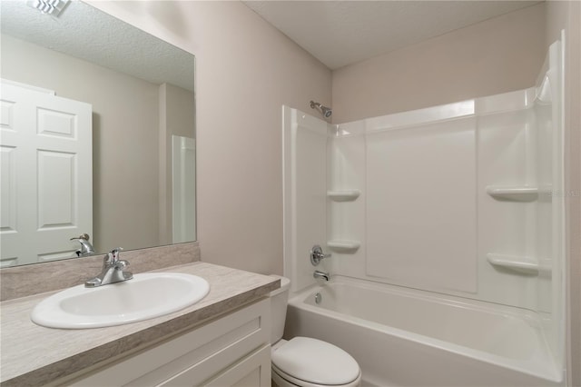 full bath with tub / shower combination, vanity, toilet, and a textured ceiling