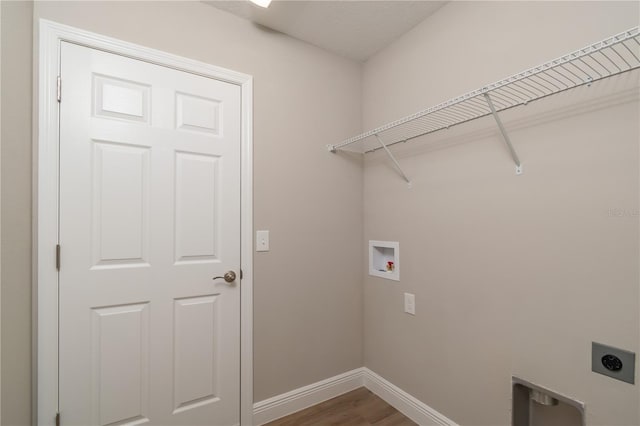 washroom with hookup for a washing machine, laundry area, wood finished floors, baseboards, and electric dryer hookup