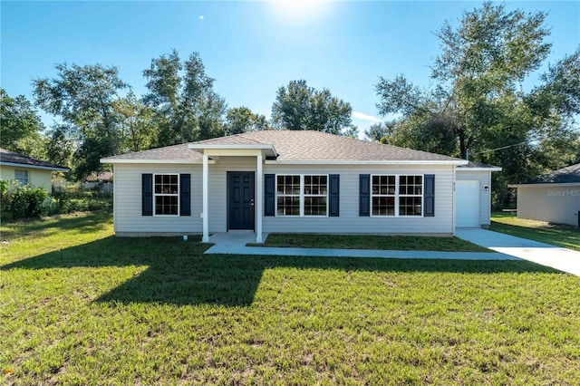 ranch-style home with a front yard, concrete driveway, a garage, and roof with shingles