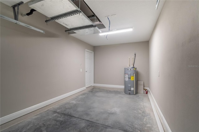 garage with baseboards and electric water heater