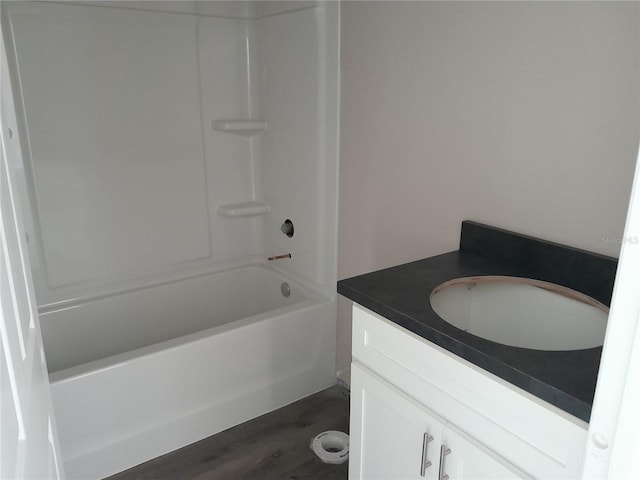 full bath featuring wood finished floors, vanity, and shower / bathtub combination