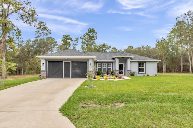 prairie-style home featuring driveway, an attached garage, stucco siding, a front lawn, and stone siding