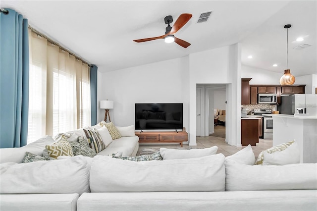 living room with a ceiling fan, visible vents, lofted ceiling, light tile patterned flooring, and recessed lighting