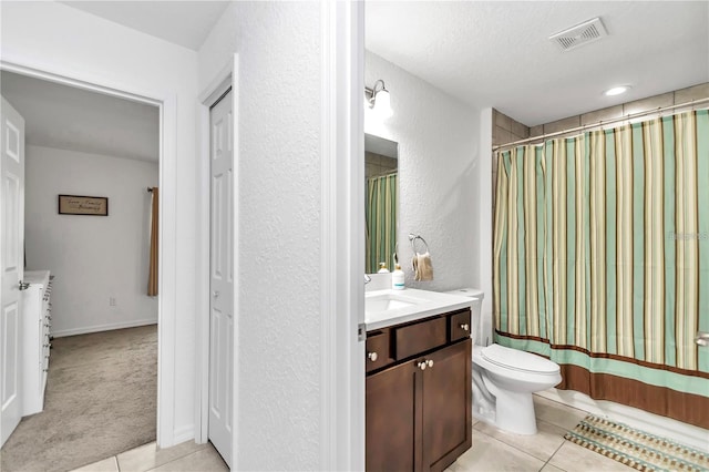 full bathroom featuring tile patterned flooring, toilet, vanity, and visible vents