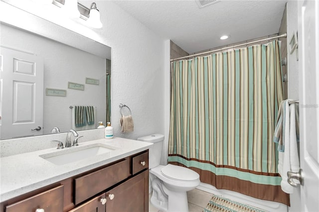 bathroom featuring vanity, a shower with curtain, tile patterned flooring, a textured ceiling, and toilet