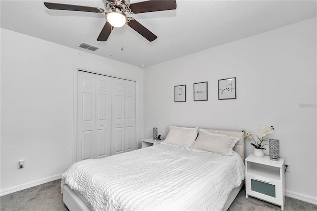 carpeted bedroom with a ceiling fan, baseboards, visible vents, and a closet