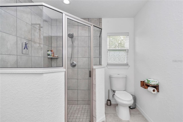 full bathroom featuring tile patterned flooring, a shower stall, toilet, and baseboards