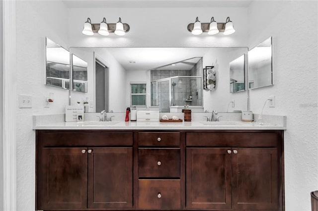 full bath featuring a sink, a stall shower, and double vanity