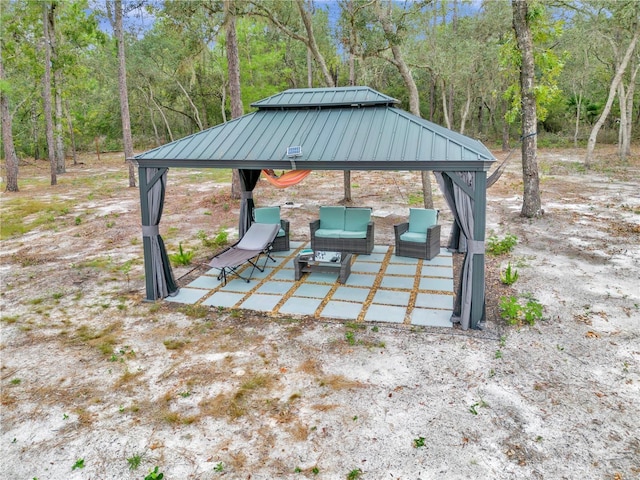 view of patio with a gazebo and a view of trees