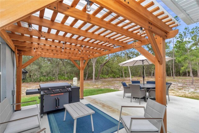 view of patio featuring outdoor dining space, area for grilling, and a pergola