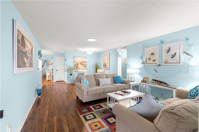 living room featuring a textured ceiling, baseboards, and hardwood / wood-style floors