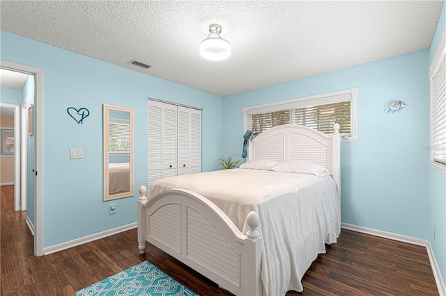 bedroom featuring a closet, baseboards, and wood finished floors