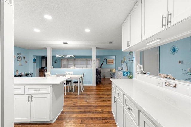 kitchen featuring white cabinets, dark wood-style floors, light countertops, and recessed lighting