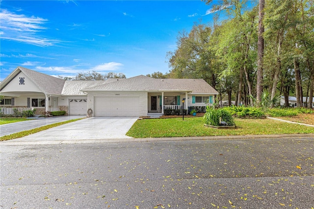 ranch-style home featuring brick siding, covered porch, concrete driveway, a garage, and a front lawn