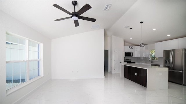 kitchen with marble finish floor, light countertops, appliances with stainless steel finishes, a kitchen island, and modern cabinets