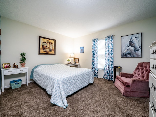 bedroom featuring dark colored carpet and baseboards