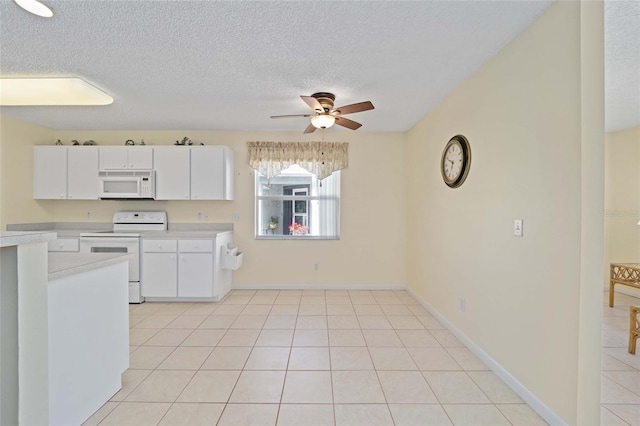 kitchen with white appliances, white cabinets, ceiling fan, light countertops, and light tile patterned flooring