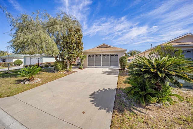 view of front of property featuring concrete driveway and stucco siding