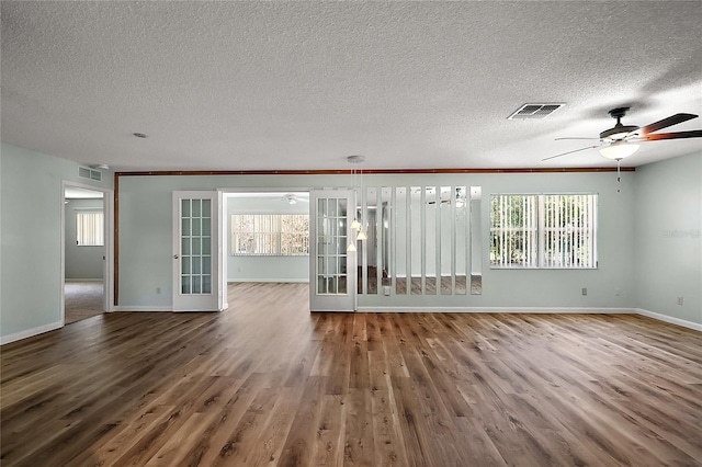 unfurnished room featuring visible vents, baseboards, ceiling fan, and wood finished floors