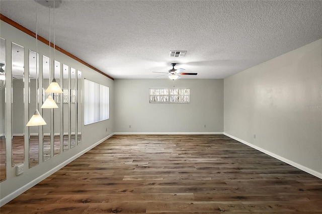 9025 SW 94th Ln Unit C, Ocala, FL 34481 - spare room featuring visible vents, baseboards, ceiling fan, a textured ceiling, and wood finished floors