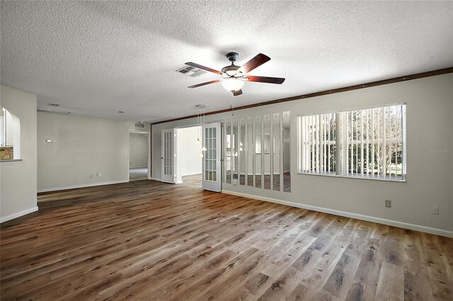 9025 SW 94th Ln Unit C, Ocala, FL 34481 - spare room with a textured ceiling, wood finished floors, ceiling fan, and baseboards