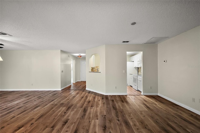 9025 SW 94th Ln Unit C, Ocala, FL 34481 - unfurnished living room with a textured ceiling, wood finished floors, baseboards, and visible vents