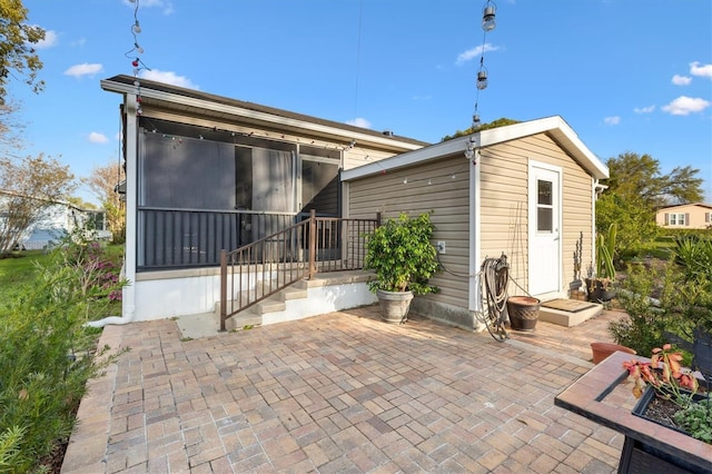 rear view of property featuring a patio area