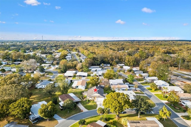 drone / aerial view featuring a residential view and a view of trees