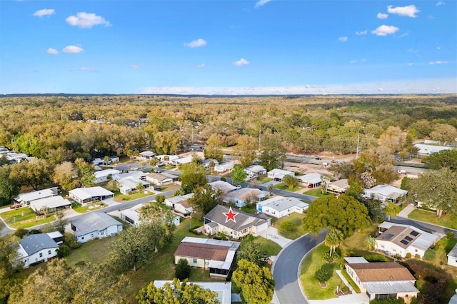 birds eye view of property featuring a residential view and a view of trees