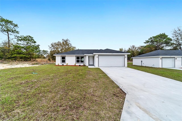 single story home featuring a garage, stucco siding, concrete driveway, and a front yard