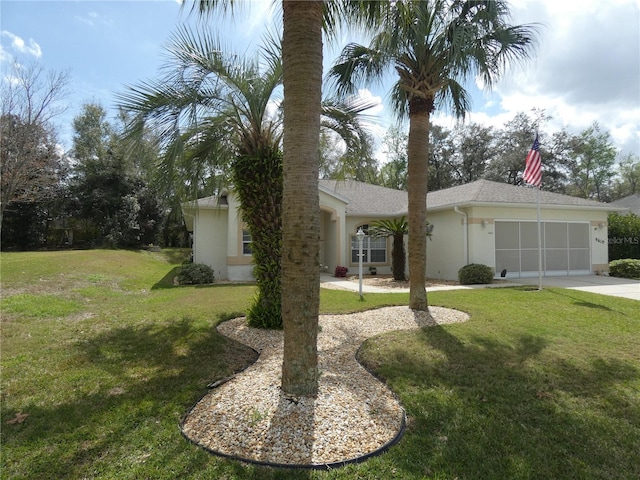 view of front of house with a garage, stucco siding, driveway, and a front yard