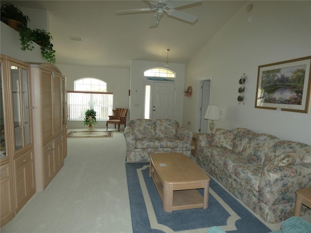 living area featuring carpet floors, ceiling fan, and high vaulted ceiling