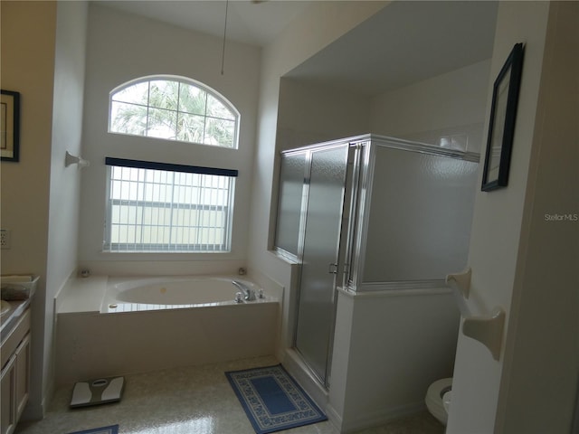 bathroom featuring toilet, a shower stall, vanity, and a bath