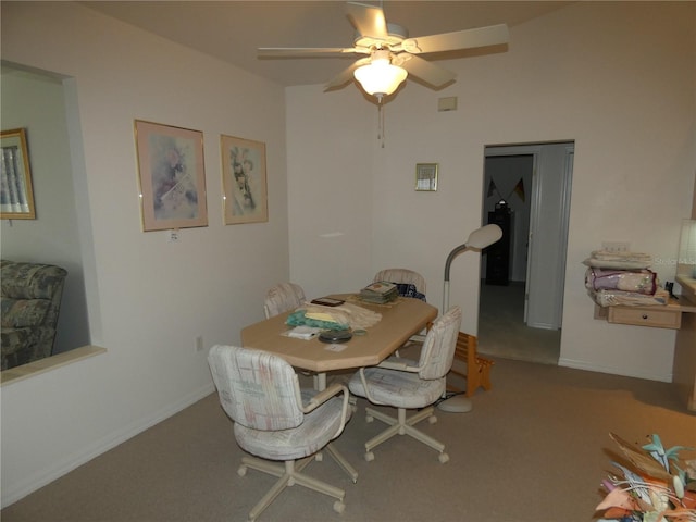 carpeted dining space featuring a ceiling fan and baseboards